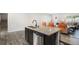 Kitchen island with granite countertops, stainless steel dishwasher and seating at 12225 Anchor Way, Hampton, GA 30228