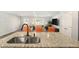 Open concept kitchen includes a granite countertop island with sink and seating at 12225 Anchor Way, Hampton, GA 30228