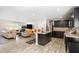 Modern open-concept living room and kitchen with hardwood floors and neutral décor at 12225 Anchor Way, Hampton, GA 30228