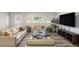 Bright living room featuring hardwood floors, large windows, and modern furnishings at 12225 Anchor Way, Hampton, GA 30228