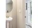 Powder room with pedestal sink and window-covered door at 12225 Anchor Way, Hampton, GA 30228