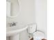 Clean powder room featuring a pedestal sink, round mirror, and toilet at 626 Pecan Knoll Dr # 13, Marietta, GA 30008