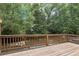 A wooden deck bordered by a railing, surrounded by verdant trees and vegetation at 626 Pecan Knoll Dr # 13, Marietta, GA 30008