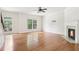 Bright living room featuring hardwood floors, a fireplace, large windows, and a ceiling fan at 626 Pecan Knoll Dr # 13, Marietta, GA 30008