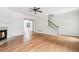 Bright living room featuring a fireplace, ceiling fan, and staircase at 626 Pecan Knoll Dr # 13, Marietta, GA 30008
