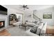 Bright living room featuring a fireplace, ceiling fan, and open access to other rooms, enhanced with staging at 626 Pecan Knoll Dr # 13, Marietta, GA 30008