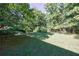 Lush green backyard featuring shade trees at 838 Lake Hollow Sw Blvd, Marietta, GA 30064