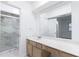 Bathroom featuring a spacious vanity with a large framed mirror and marble shower at 838 Lake Hollow Sw Blvd, Marietta, GA 30064