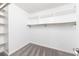 Walk-in closet featuring neutral carpet and ample storage space with built-in shelving at 838 Lake Hollow Sw Blvd, Marietta, GA 30064