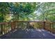 Wood deck surrounded by mature trees offering privacy at 838 Lake Hollow Sw Blvd, Marietta, GA 30064