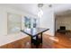 Bright dining area featuring wood floors, a modern light fixture, and multiple windows with outside views at 838 Lake Hollow Sw Blvd, Marietta, GA 30064