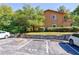 Cozy brown two-story home with lush landscaping, parking spots, and steps to the front entrance at 838 Lake Hollow Sw Blvd, Marietta, GA 30064
