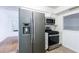 Stainless steel refrigerator and oven, with view into adjoining dining room at 838 Lake Hollow Sw Blvd, Marietta, GA 30064