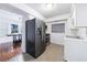 Galley style kitchen with tile flooring, modern appliances, and white cabinets at 838 Lake Hollow Sw Blvd, Marietta, GA 30064