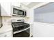 Stainless steel stove and microwave with white cabinets at 838 Lake Hollow Sw Blvd, Marietta, GA 30064