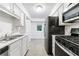 Basement kitchenette with stainless appliances and white cabinetry at 838 Lake Hollow Sw Blvd, Marietta, GA 30064