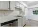 Basement kitchenette area features white cabinets and stainless steel dishwasher at 838 Lake Hollow Sw Blvd, Marietta, GA 30064