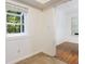 Tiled bonus room featuring windows, white walls, and doorway at 838 Lake Hollow Sw Blvd, Marietta, GA 30064