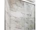 Modern shower stall with glass doors and upscale marble-patterned tile surround at 838 Lake Hollow Sw Blvd, Marietta, GA 30064