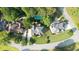 Aerial view of neighborhood featuring houses with pools, lush landscaping, and tree-lined streets at 9310 Chapelwood Dr, Johns Creek, GA 30022