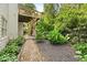 Backyard with a wooden deck, stairs, gravel path, and garden beds at 9310 Chapelwood Dr, Johns Creek, GA 30022