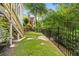 Fenced backyard with lush lawn and access to the deck stairs, blending indoor/outdoor living at 9310 Chapelwood Dr, Johns Creek, GA 30022