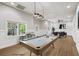 Staged basement features hardwood floors, billiards table, bar table, and recessed lights at 9310 Chapelwood Dr, Johns Creek, GA 30022