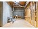 Unfinished basement area with concrete walls, exposed ceiling, storage shelves, and workspace at 9310 Chapelwood Dr, Johns Creek, GA 30022