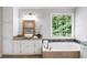 This bright bathroom offers a granite countertop, garden tub, and large window at 9310 Chapelwood Dr, Johns Creek, GA 30022