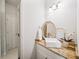 Powder room featuring a modern sink, granite countertops, and a decorative mirror at 9310 Chapelwood Dr, Johns Creek, GA 30022