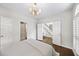 Bedroom featuring hardwood floors, white walls, and a doorway into another room with a staircase at 9310 Chapelwood Dr, Johns Creek, GA 30022