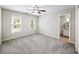 Neutral bedroom with carpet, ceiling fan, natural light, and view to ensuite bathroom at 9310 Chapelwood Dr, Johns Creek, GA 30022