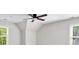 Light-filled bedroom featuring a ceiling fan, two windows, and neutral colors at 9310 Chapelwood Dr, Johns Creek, GA 30022