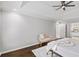 Neutral bedroom with a trey ceiling, ceiling fan, wood floors, ensuite bathroom, and natural light at 9310 Chapelwood Dr, Johns Creek, GA 30022