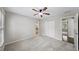 Spacious bedroom features plush carpeting, a ceiling fan, and a neutral color palette at 9310 Chapelwood Dr, Johns Creek, GA 30022