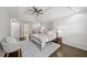 This bedroom offers a tray ceiling, ceiling fan, neutral paint, and an ensuite bathroom with tub at 9310 Chapelwood Dr, Johns Creek, GA 30022