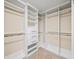 Large walk-in closet featuring built-in shelving units and plenty of storage space at 9310 Chapelwood Dr, Johns Creek, GA 30022