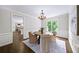 Elegant dining room with chandelier, large window, and decorative rug at 9310 Chapelwood Dr, Johns Creek, GA 30022