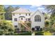 Back exterior of home with large windows, deck, stairway and fenced yard at 9310 Chapelwood Dr, Johns Creek, GA 30022