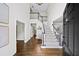 Grand foyer with high ceilings, wood floors, and staircase offers a welcoming entrance to the home at 9310 Chapelwood Dr, Johns Creek, GA 30022