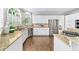 Bright, updated kitchen with granite countertops, stainless steel appliances, and large windows at 9310 Chapelwood Dr, Johns Creek, GA 30022