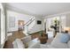 Spacious living room featuring hardwood floors, a staircase, and an adjacent dining room and bedroom at 9310 Chapelwood Dr, Johns Creek, GA 30022