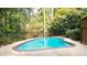 Private backyard pool features a brick trim and surrounding patio for relaxation at 9310 Chapelwood Dr, Johns Creek, GA 30022