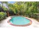 Backyard pool with patio, surrounded by lush greenery and trees at 9310 Chapelwood Dr, Johns Creek, GA 30022