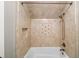 Close-up of a shower featuring tiled walls, a built-in niche, and modern fixtures at 9310 Chapelwood Dr, Johns Creek, GA 30022