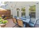 Back deck featuring an outdoor dining set, fire pit, outdoor lighting, and manicured plants at 1382 Doublegate Ne Dr, Atlanta, GA 30319
