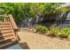 Backyard includes stone landscaping, wooden staircase, wrought iron fence, and trimmed shrubs at 1382 Doublegate Ne Dr, Atlanta, GA 30319