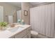 A clean bathroom with a single sink vanity, a framed mirror, and a shower with a white curtain at 1382 Doublegate Ne Dr, Atlanta, GA 30319