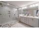 Elegant bathroom with a walk-in shower, dual vanity, and marble tile at 1382 Doublegate Ne Dr, Atlanta, GA 30319