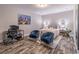 A modern bedroom that offers a desk space, calming wall art, and blue velvet chairs at 1382 Doublegate Ne Dr, Atlanta, GA 30319